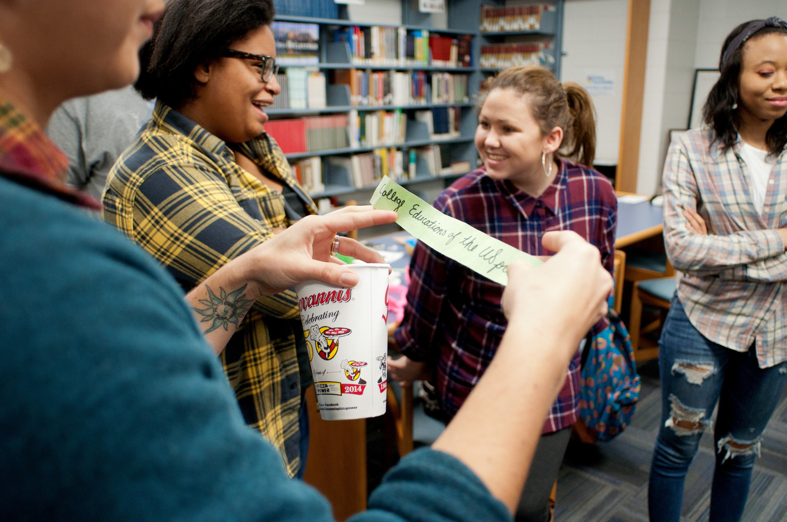 High school students standing in a school library talking together