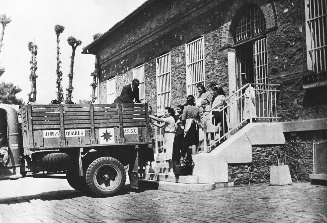 Black and white photo of truck being loaded with supplies during world war 2