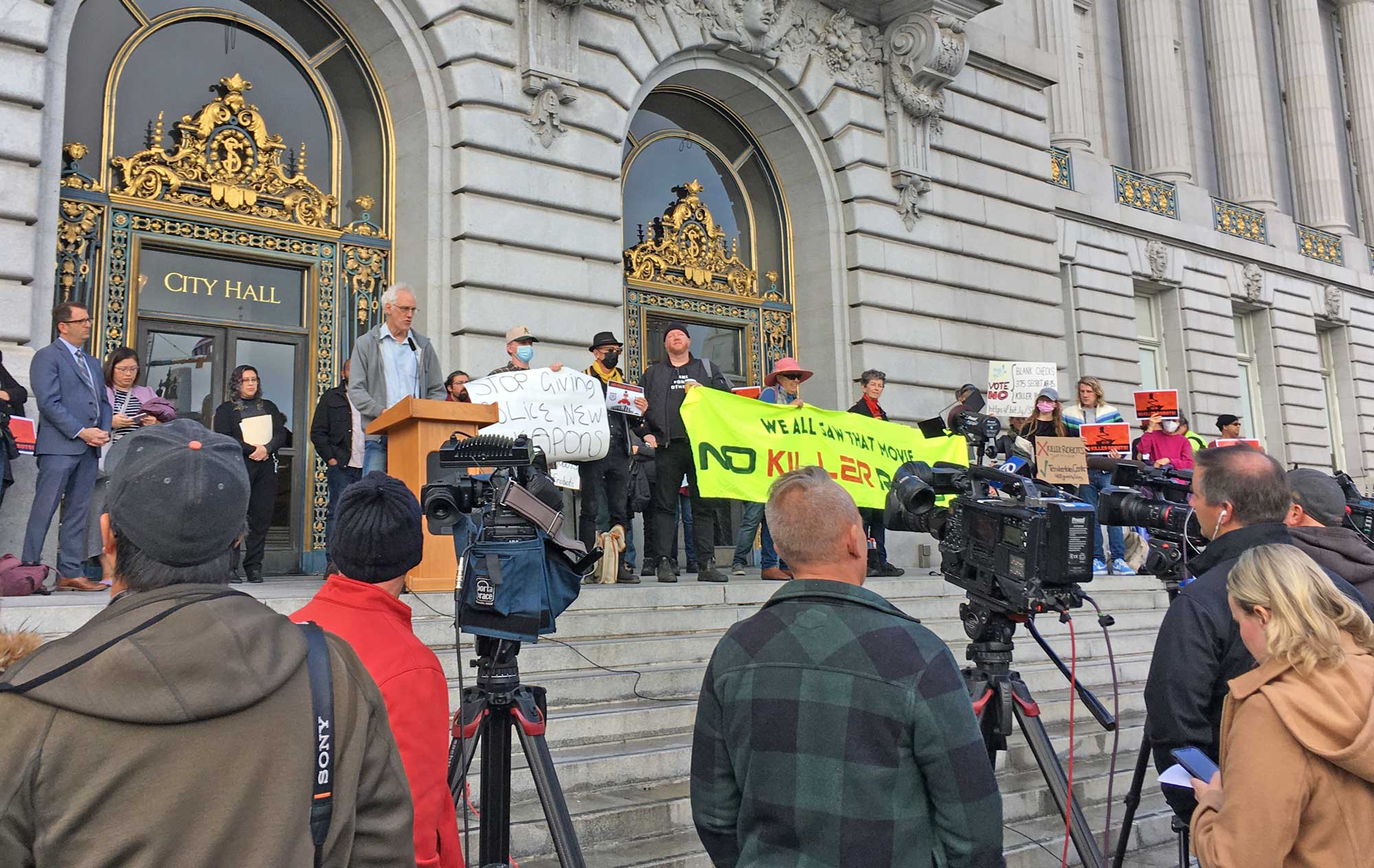 An organizer addresses a press conference from the steps of San Francisco City hall, concerning police use of killer robots