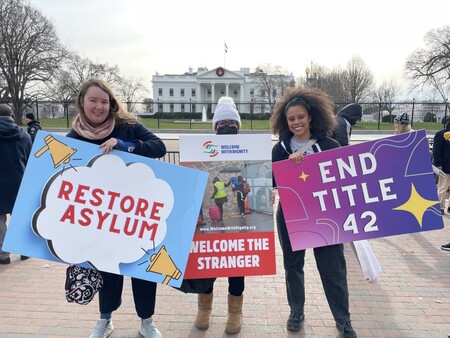 3 people hold signs in front of White House to restore asylum