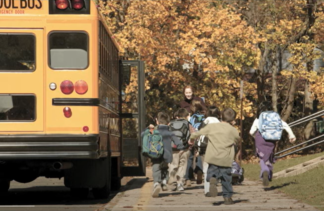 Children running to school bus