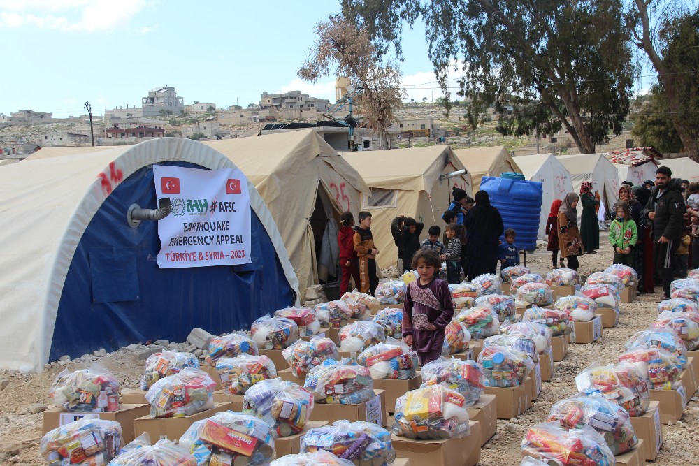 A child walks among rows of bags and boxes of food