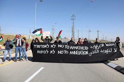 Group of people hold black banner in the street