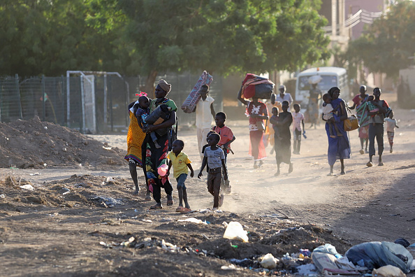 People with belongings leaving Sudan