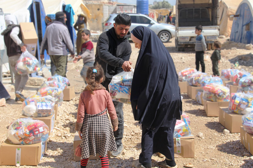 woman and child receiving supplies after earthquake in Turkey and Syria