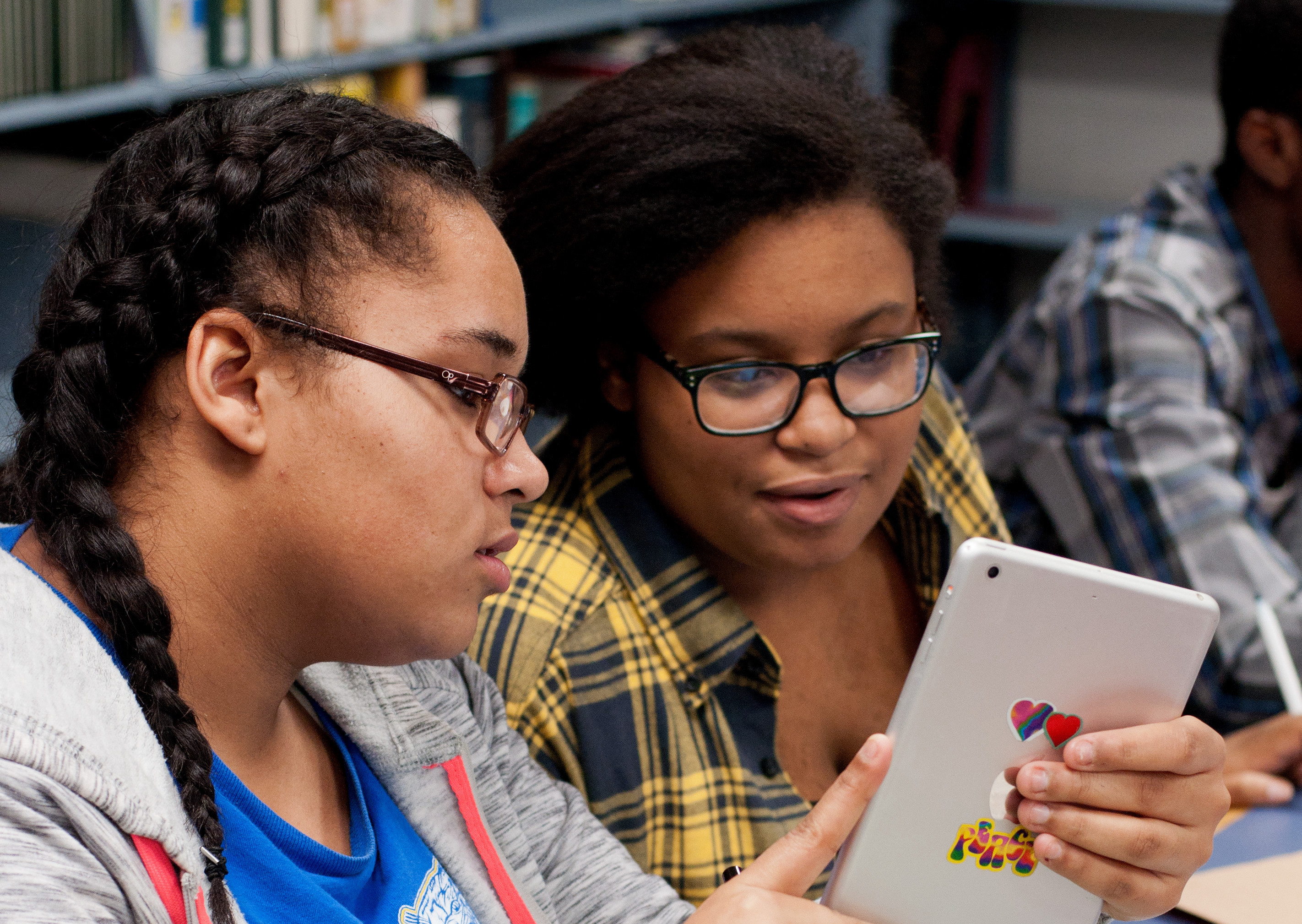 Image of two students looking at a tablet