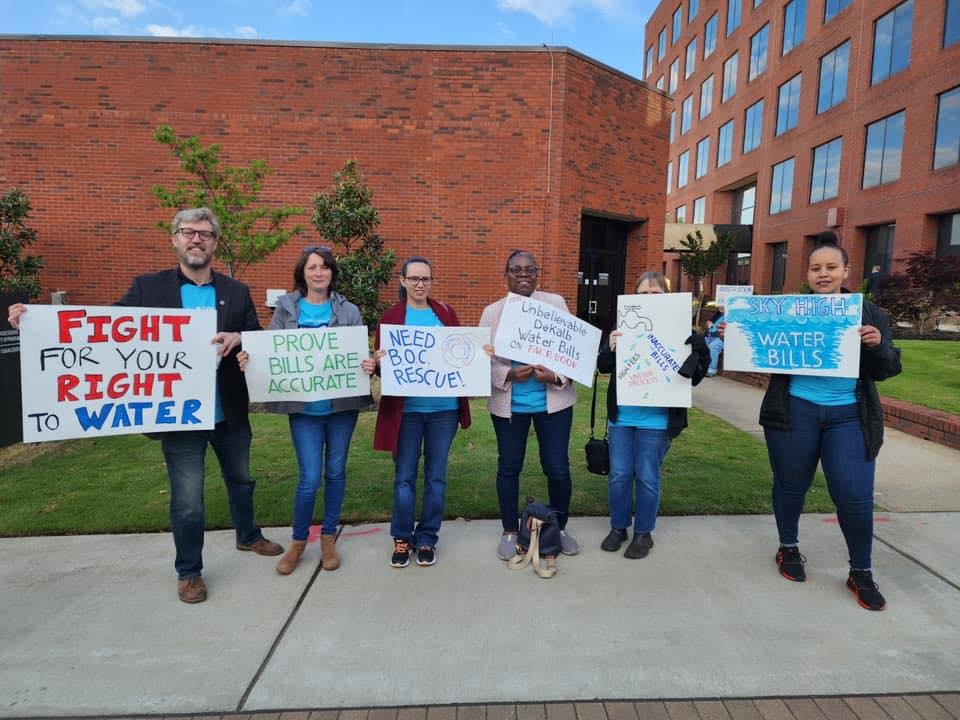 holding signs that read fight for your right to water