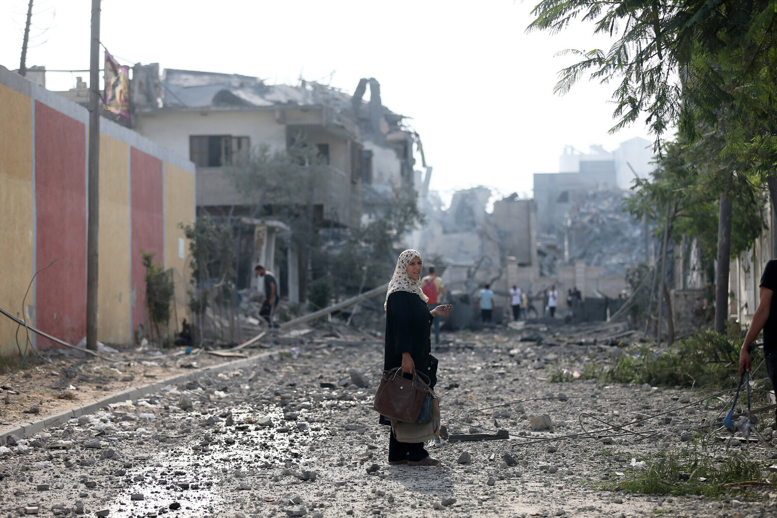 DESCRIPTIONA Palestinian woman stands in the middle of the massive destruction caused by Israeli airstrikes in Gaza City
