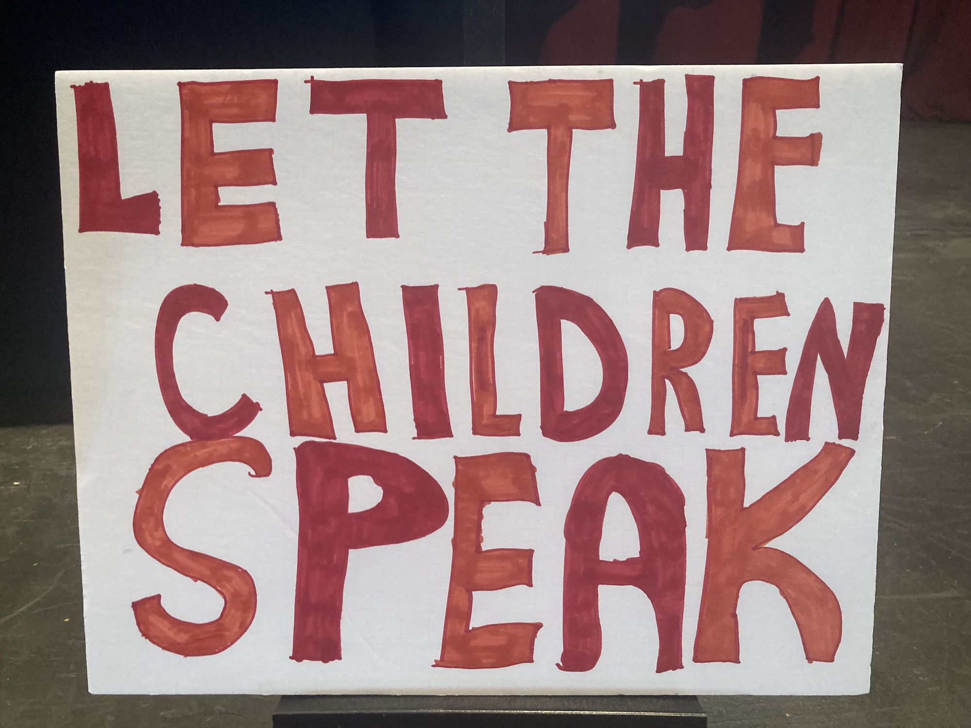Poster that says 'Let the children speak'