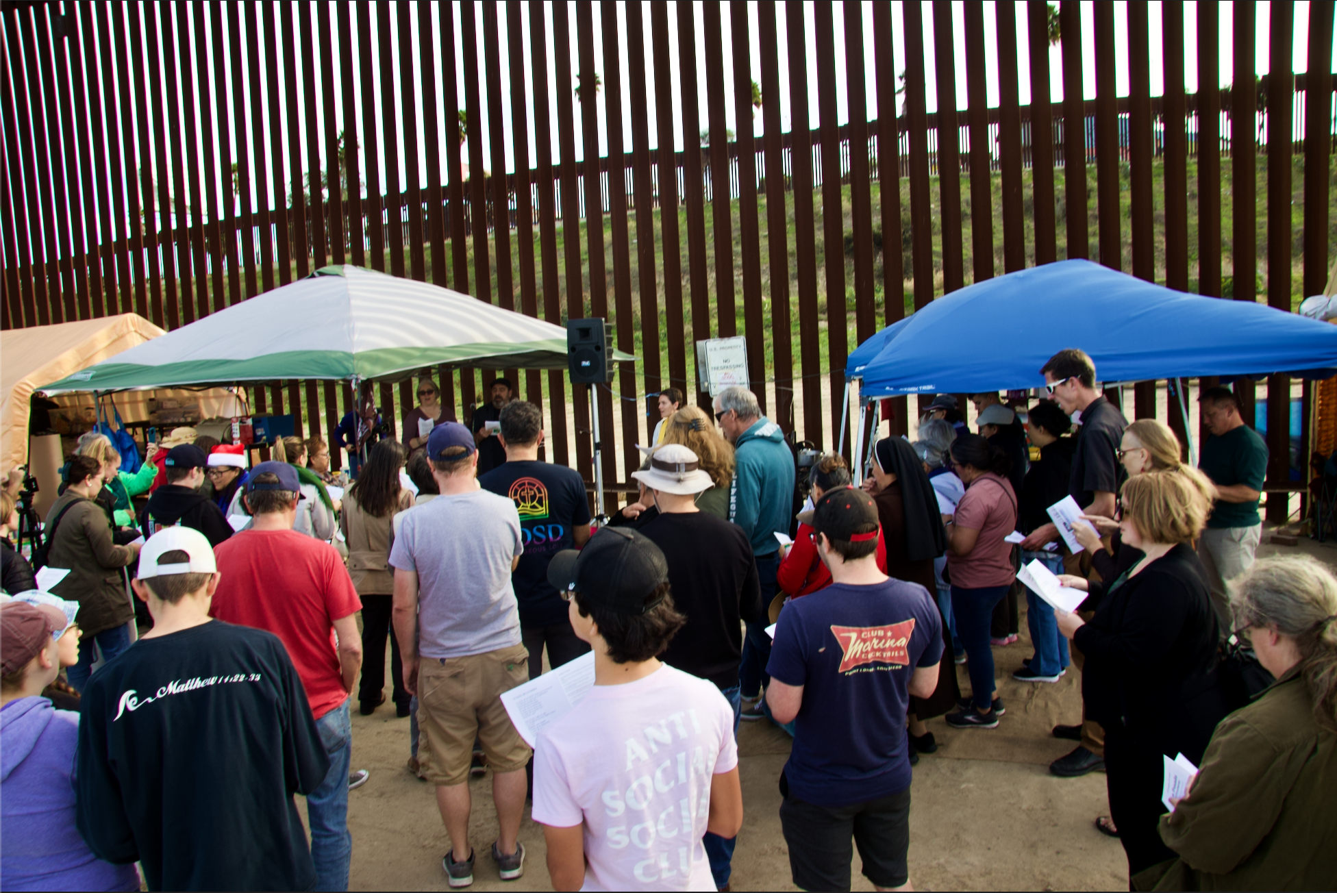 Gathering of people at U.S.-Mexico border wall