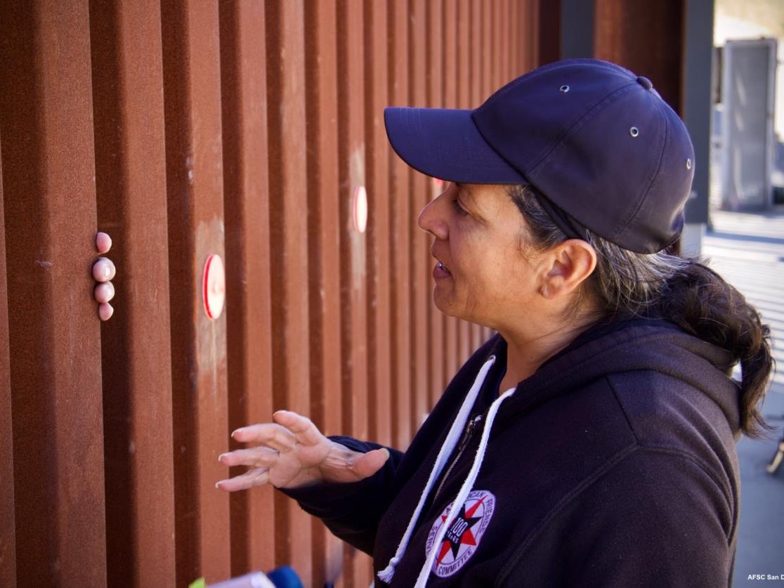 AFSC Staffperson Adriana Jasso connecting through the border wall