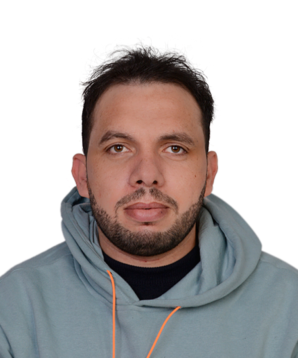 A headshot of a man in a gray hoodie