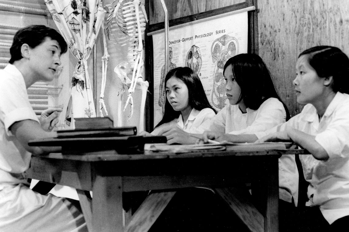 Four women sitting around a table at a medical clinic