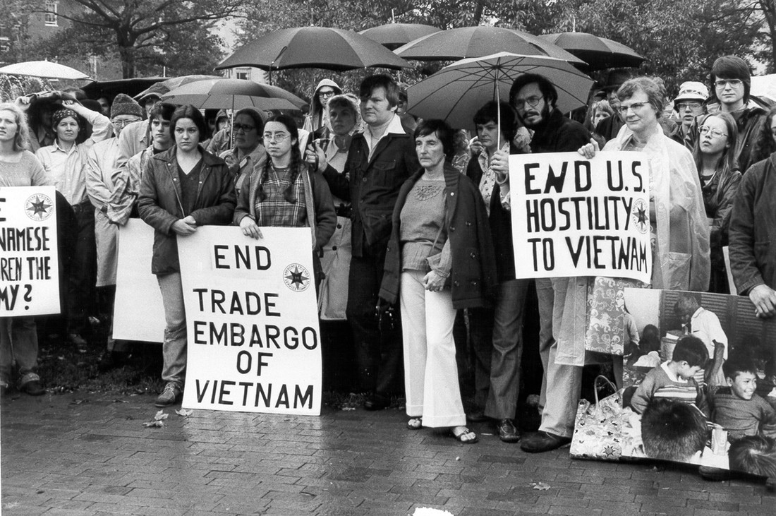 Group of anti-war protesters with umbrellas in the rain