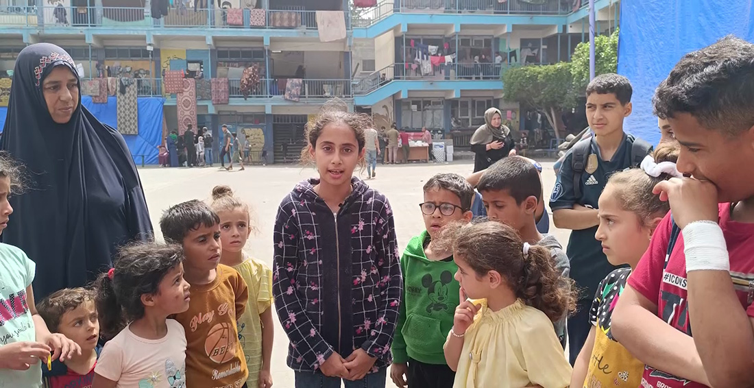 A young child in a Gaza refugee camp talking to the camera