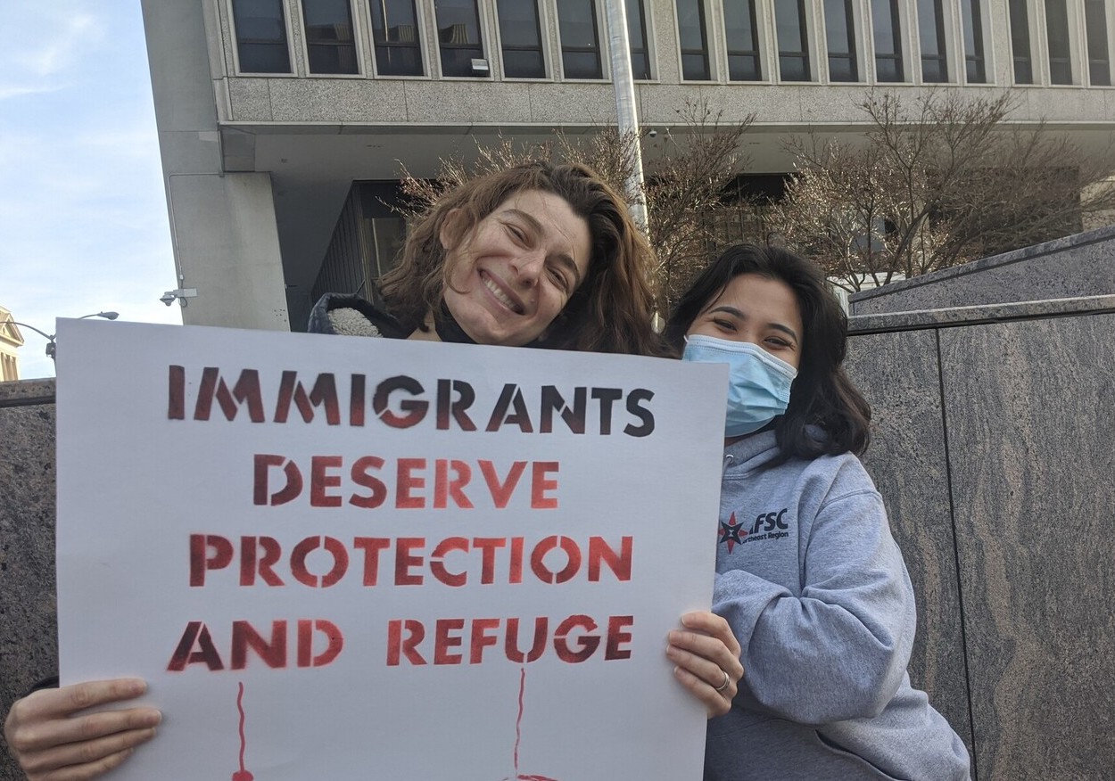 2 people hold sign that say 