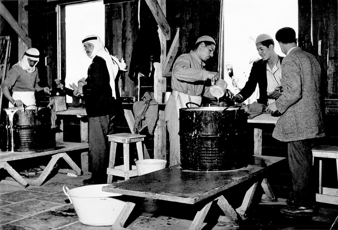 Distributing food from a large pot.