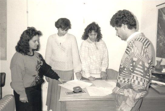 Four people standing around a desk