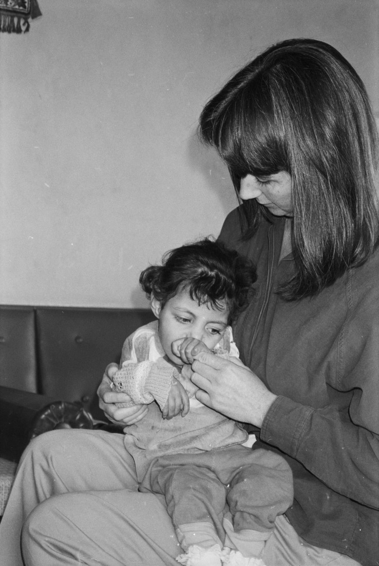 Woman sitting with a young child in her lap