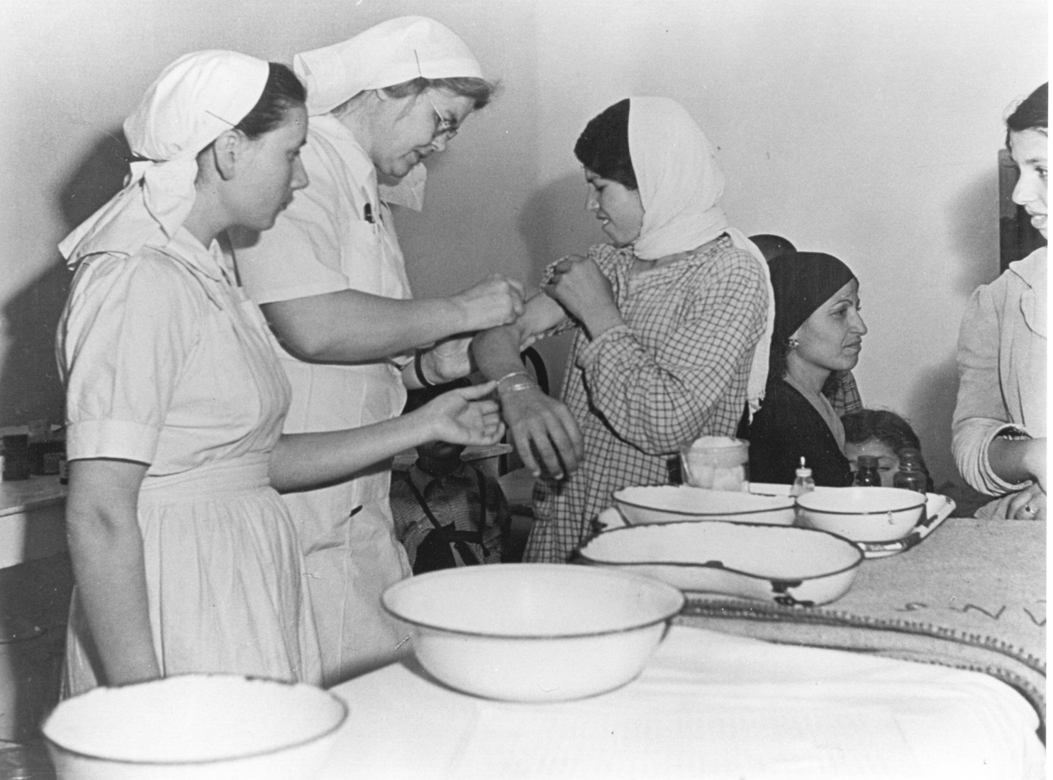 Woman receiving an inoculation shot at a clinic.