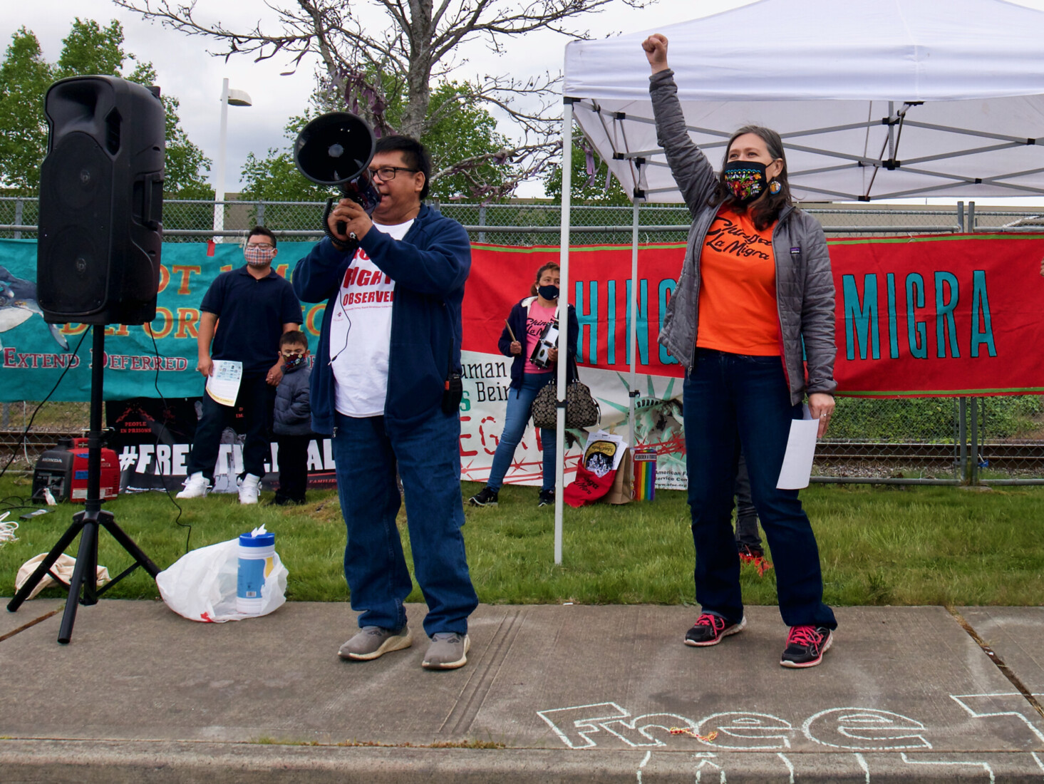 Protestors with loudspeaker and fist raised