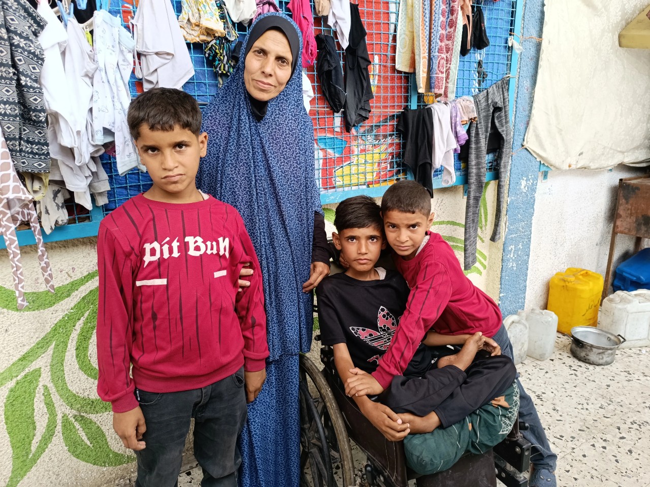 Woman stands with her 3 sons 