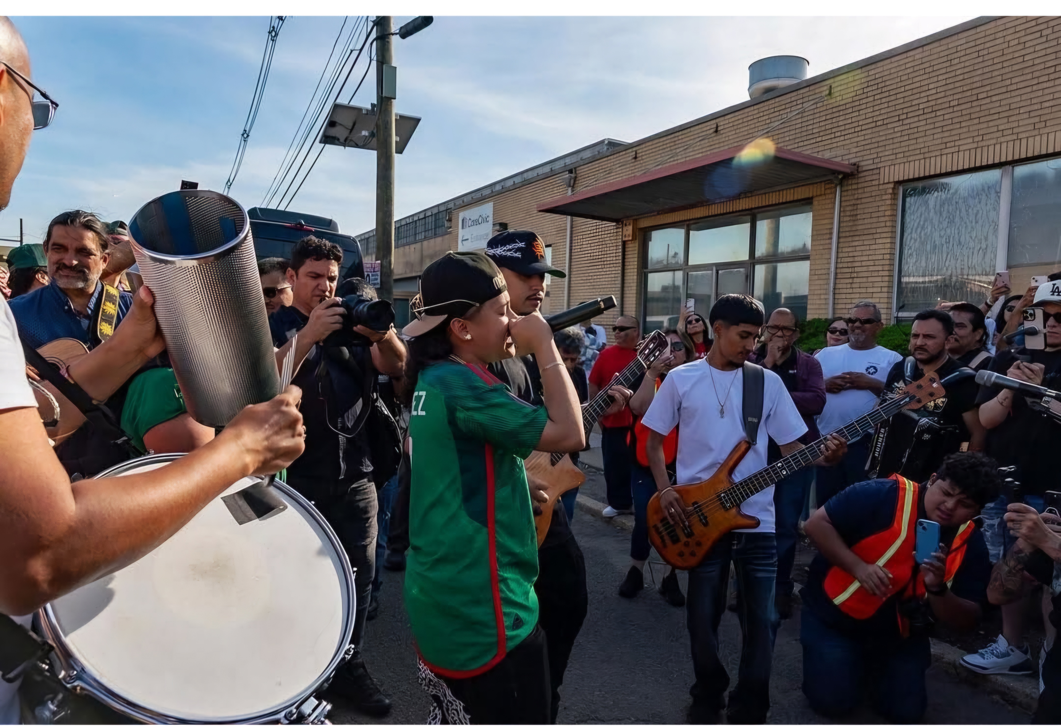 People protesting and playing music outside a for-profit detention center