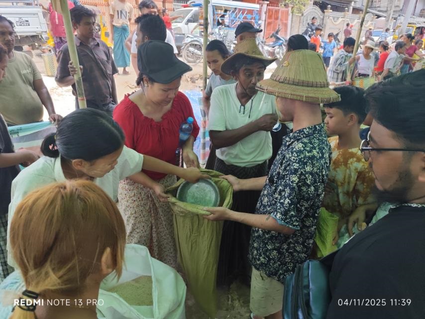 People hand out rice from bags 