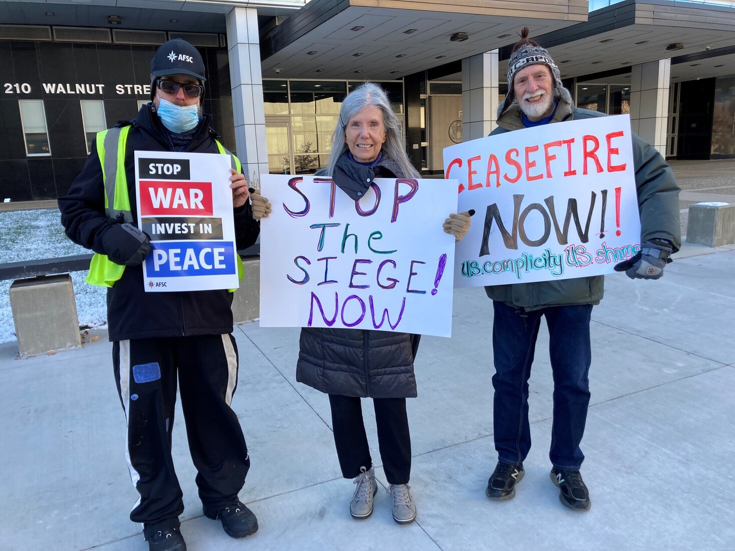 Quakers hold signs advocating for peace