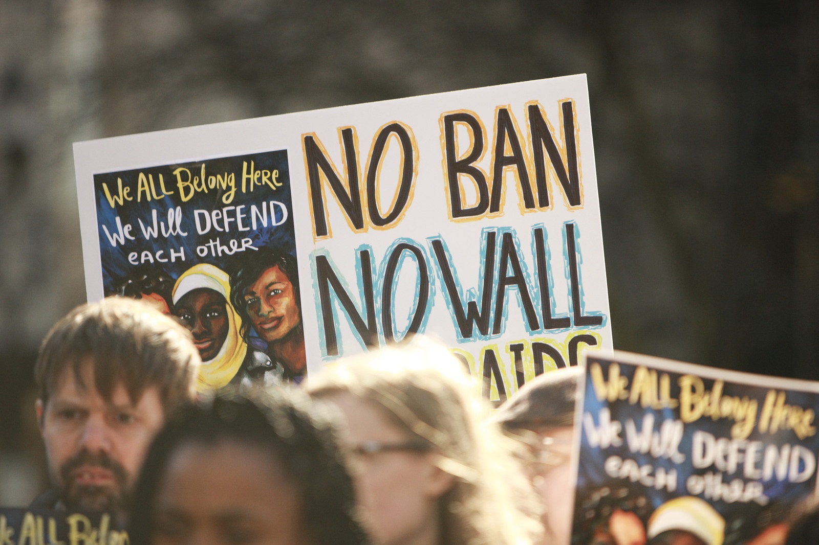 A protest sign in a crowd that says 