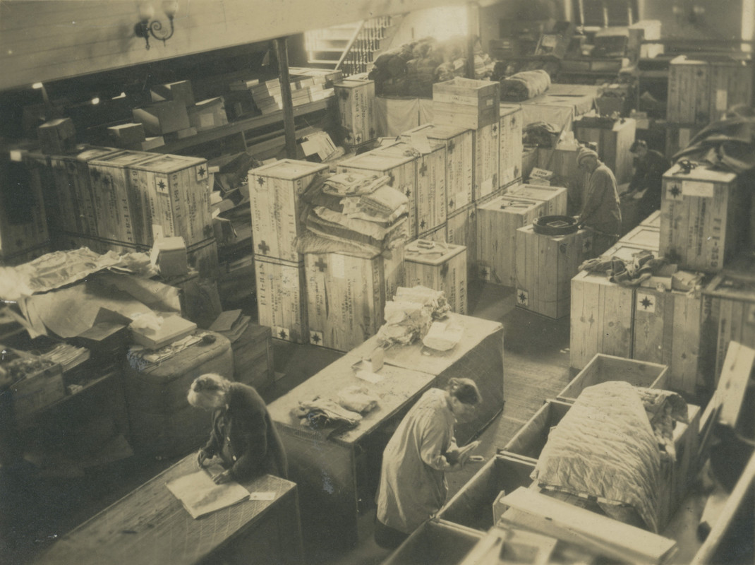 Black and white photograph of a warehouse full of boxes