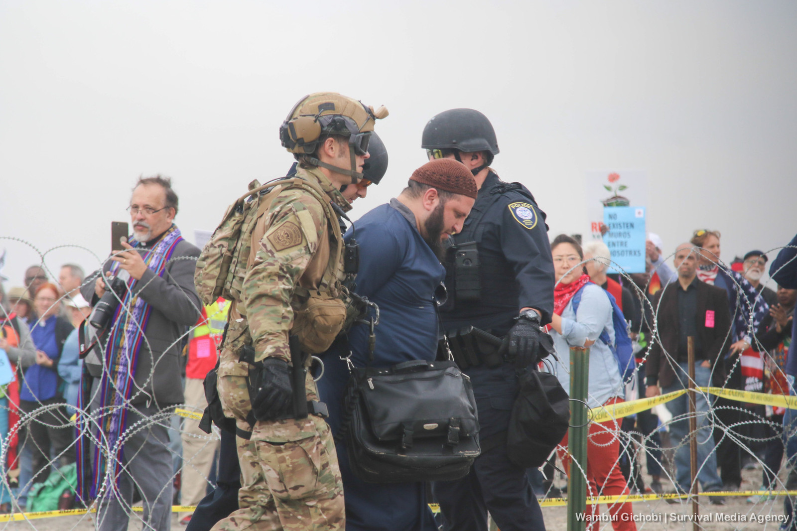 Man being arrested by border patrol agents