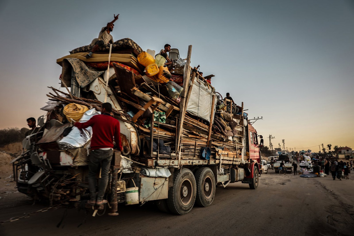 A truck filled to the brim with belongings and people