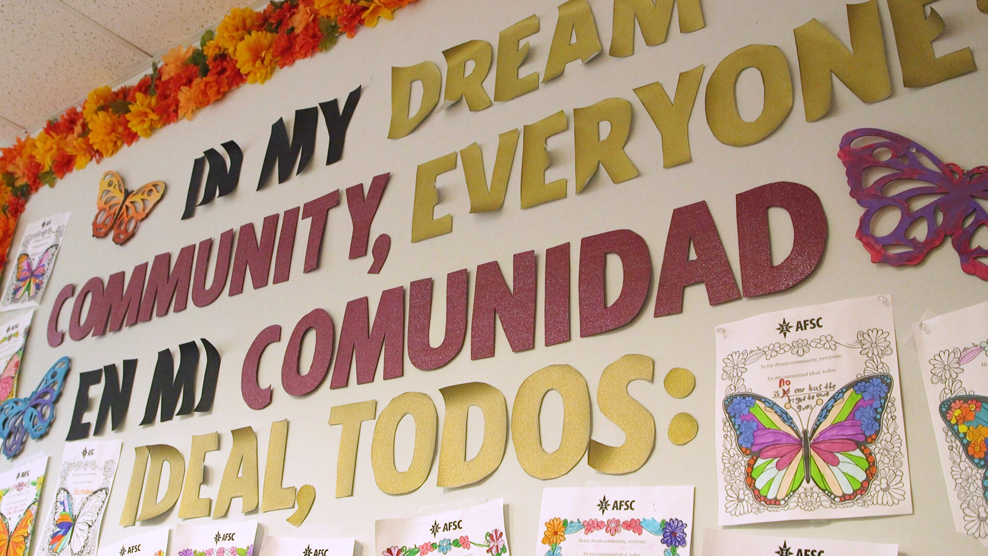 Photo of an office wall decorated with pro-immigration artwork