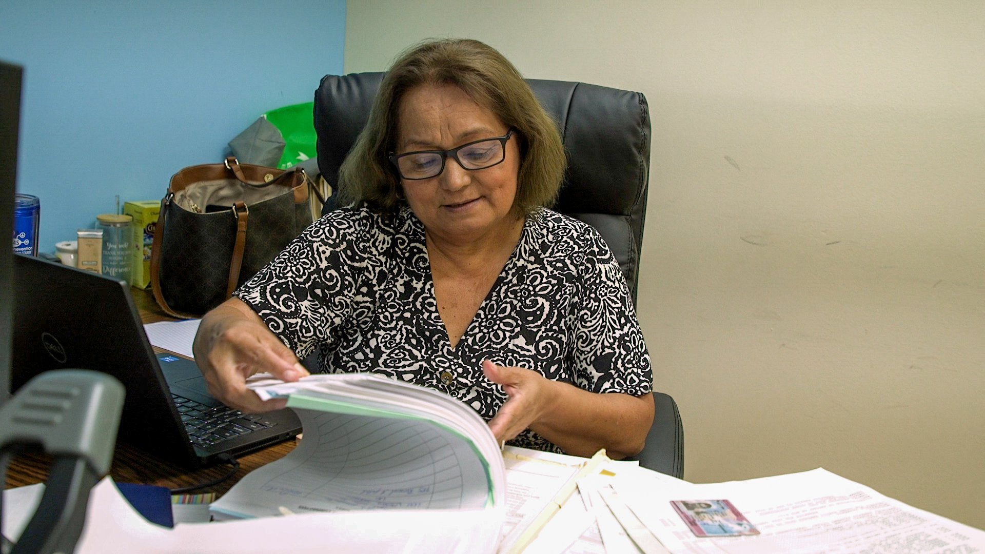 woman lawyer flipping through paperwork immigration
