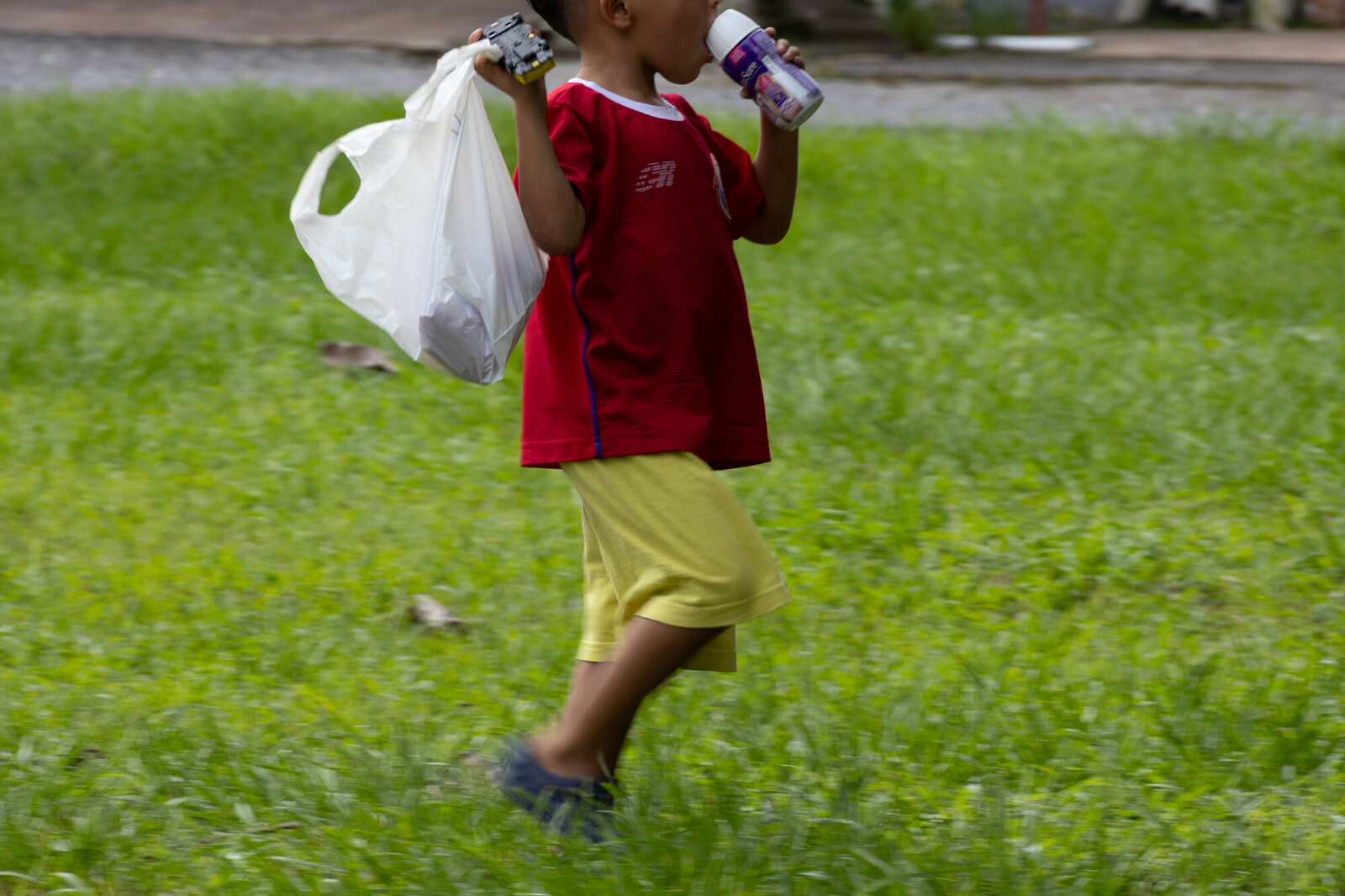 photo of young boy holding supplies