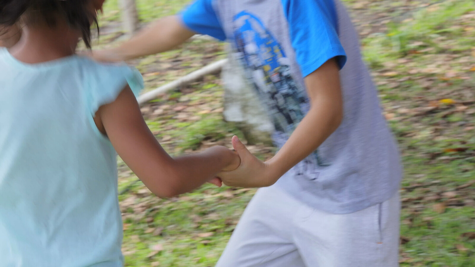 children outside playing in circle holding hands