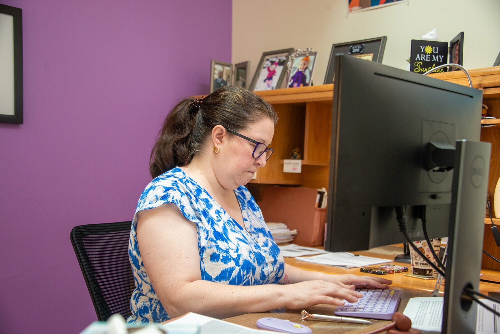 woman lawyer typing on computer purple background