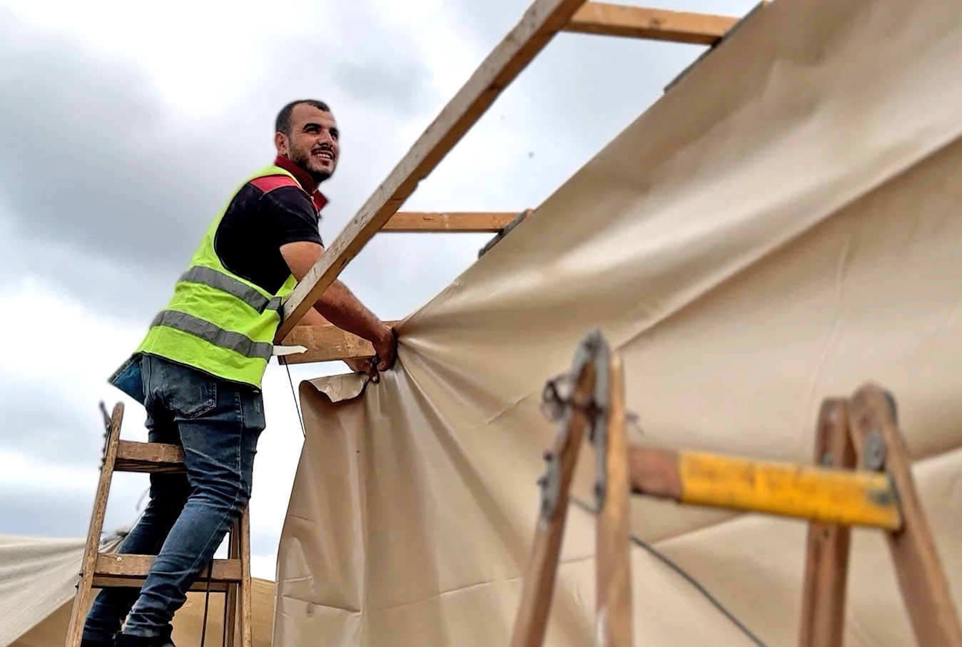 A construction worker standing on a ladder