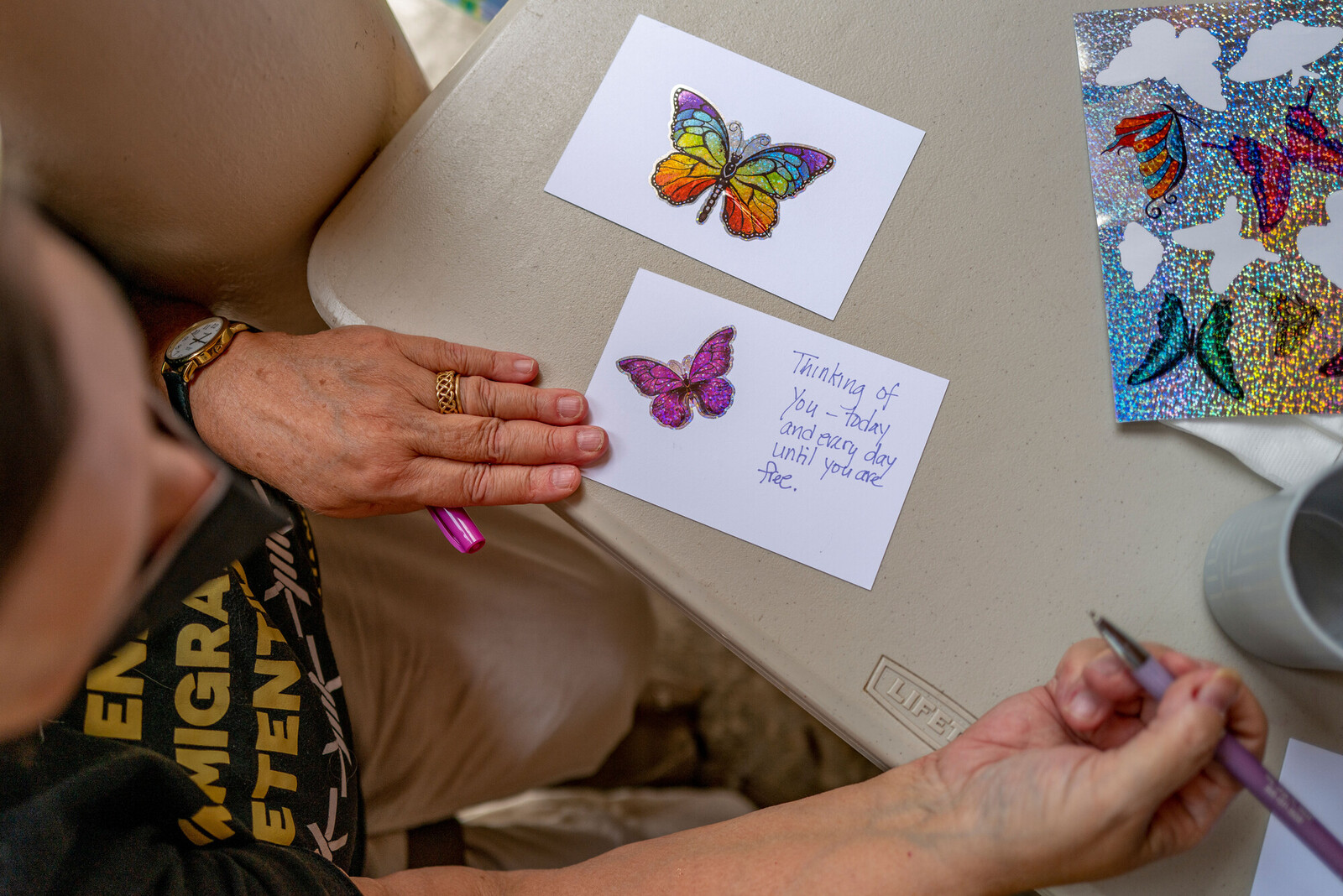 person writing a letter with butterfly