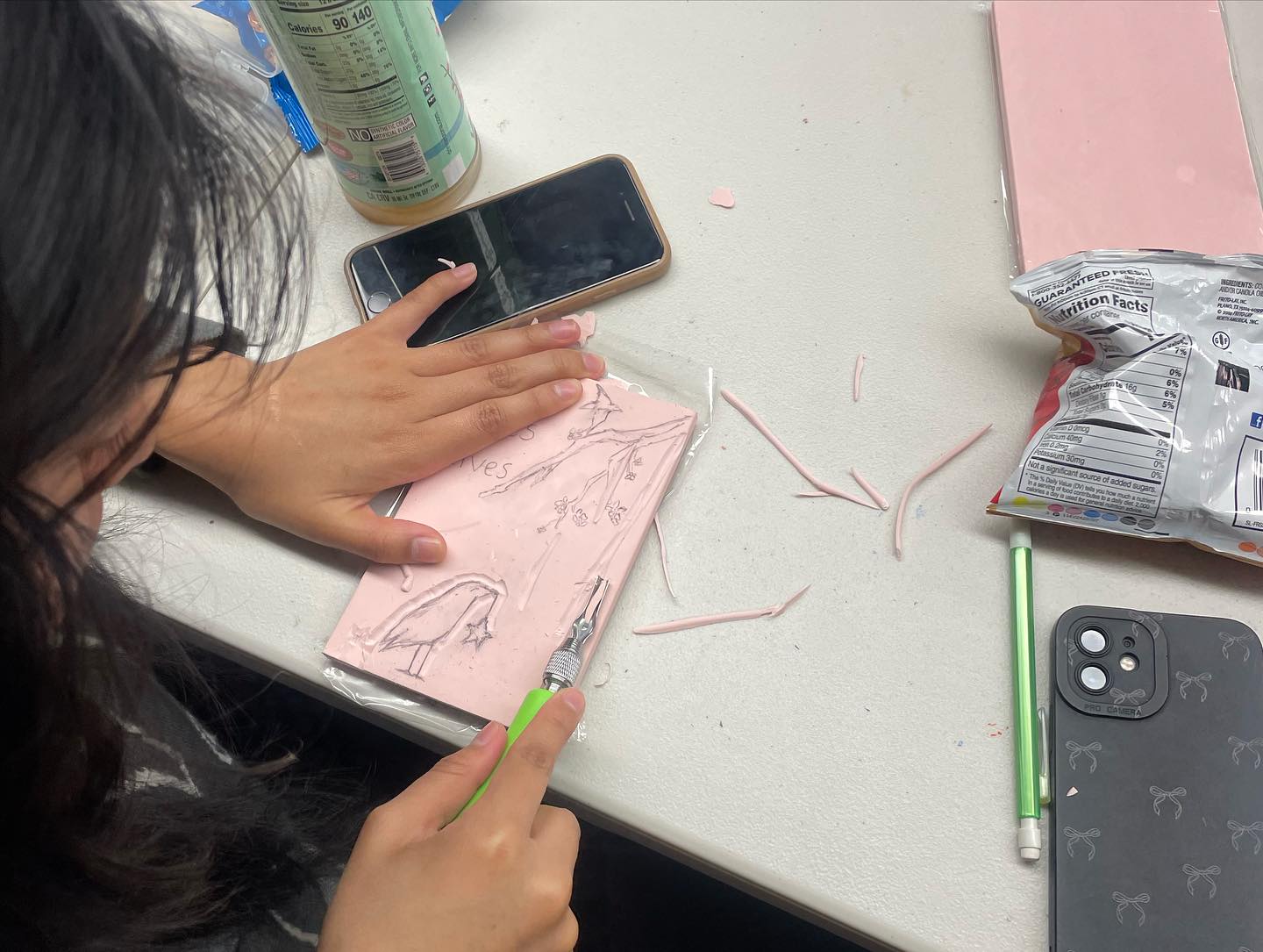 67 student working on a LinoCut