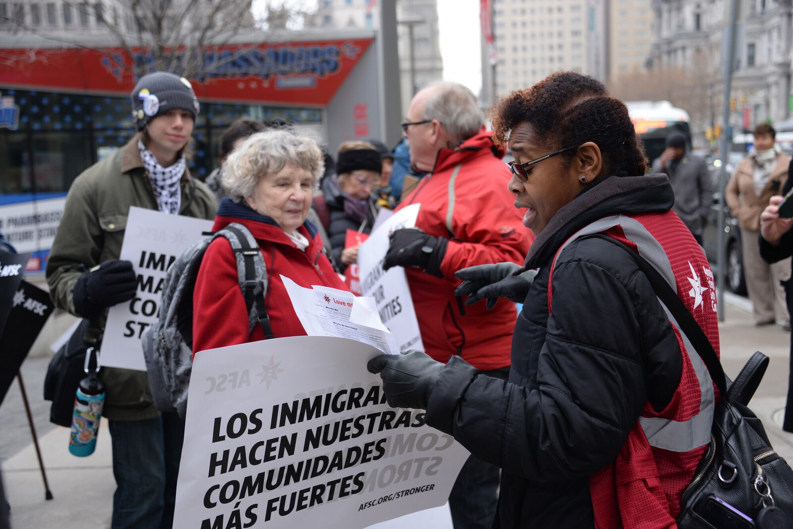 An AFSC volunteer hands out information about the Love as Action vigil