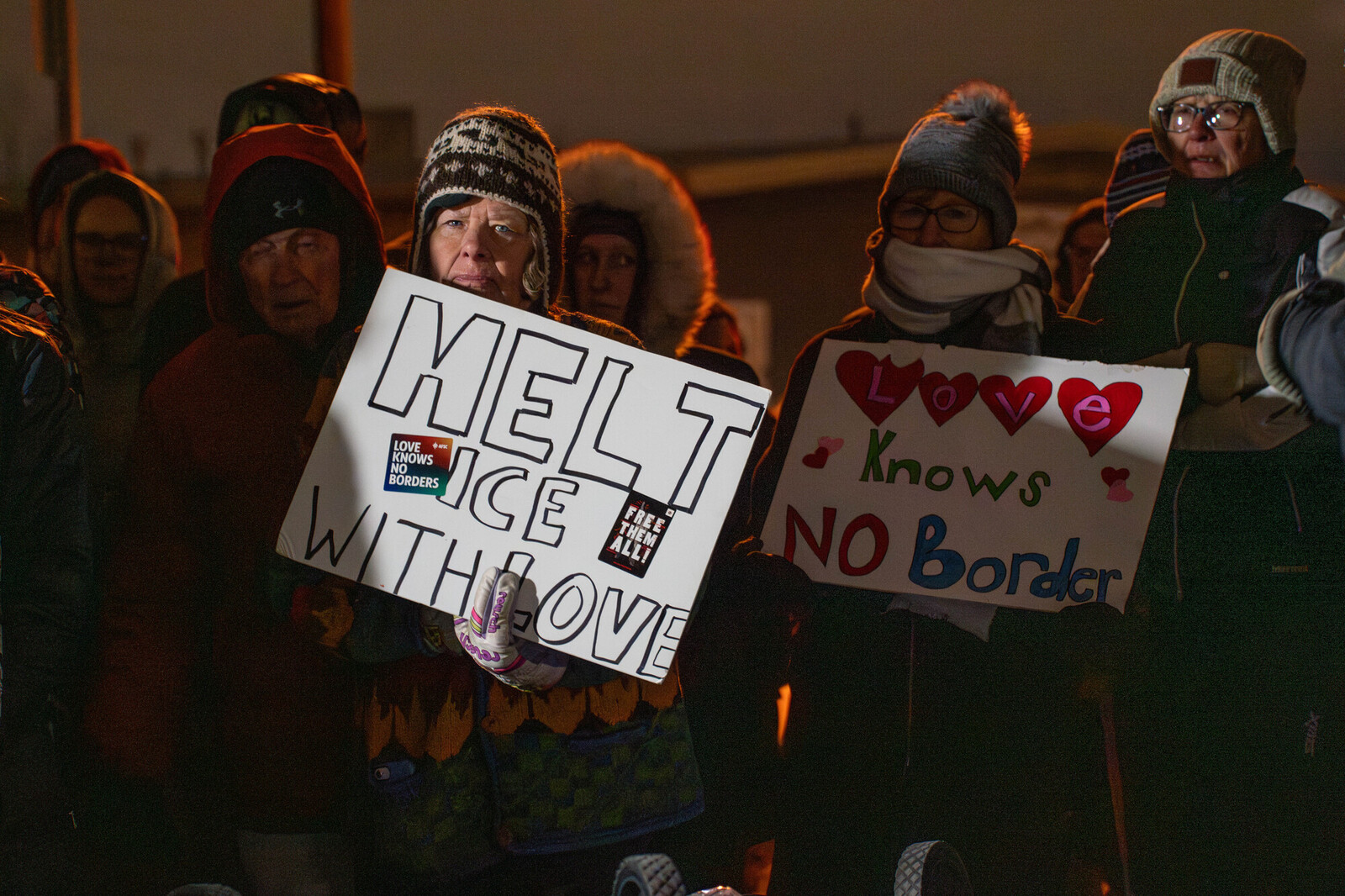 people holds signs that read 