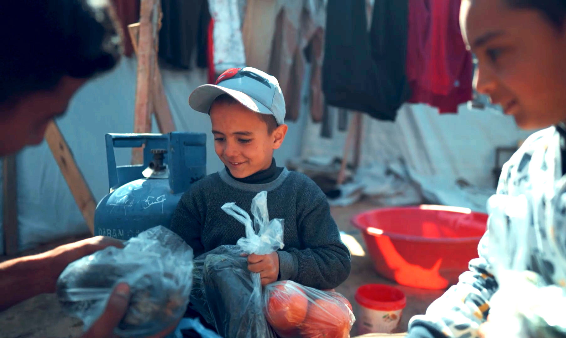 Young child receiving a bag of fresh fruit
