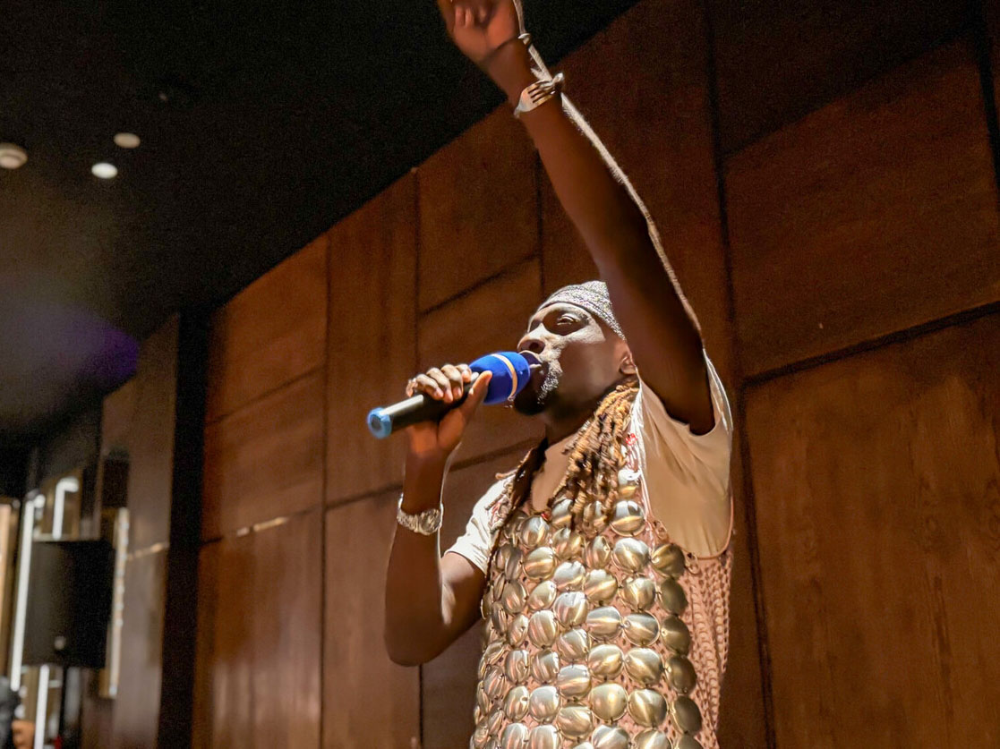 Man speaking into a handheld microphone