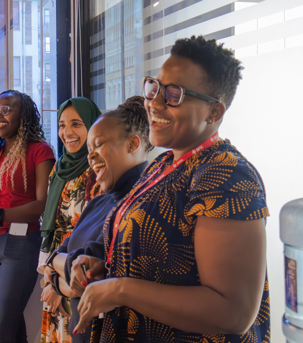 grouop of women laughing in conference room