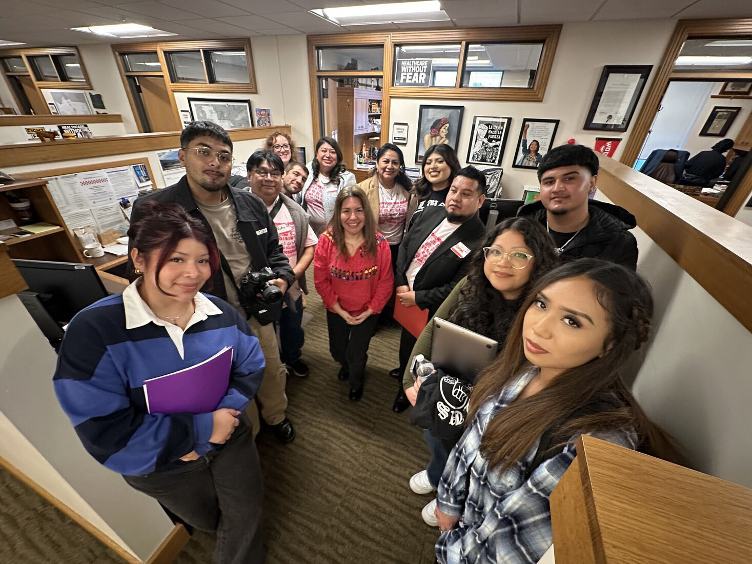 Group of young activists standing together indoors