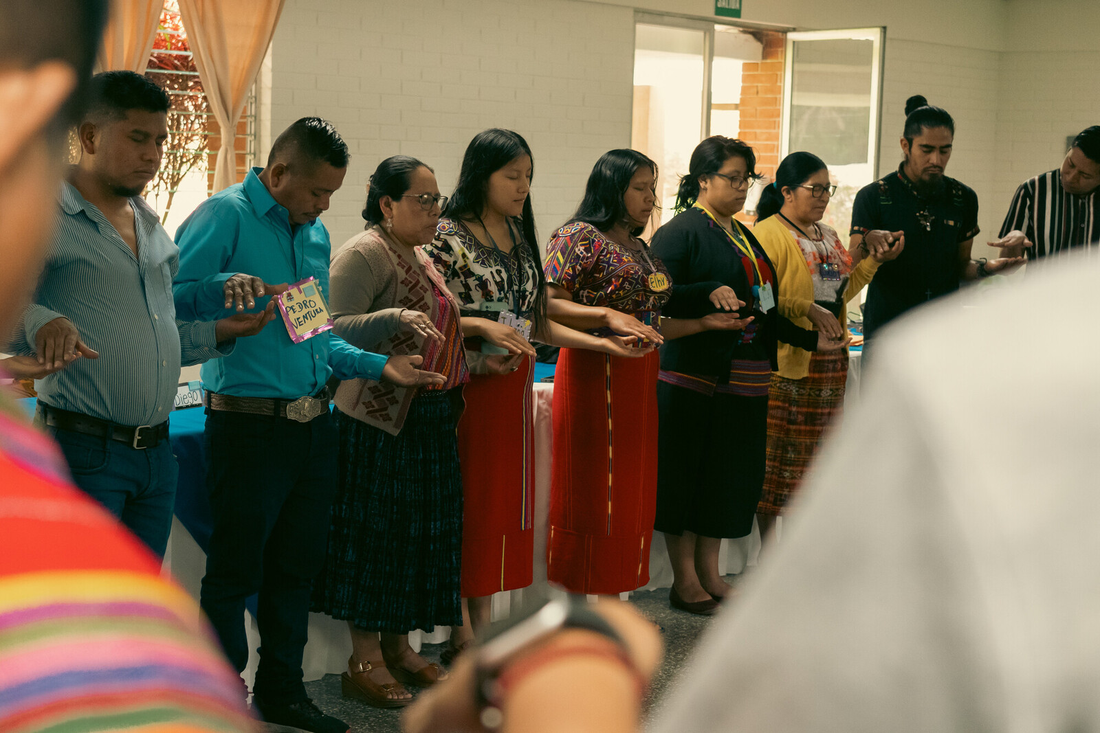 photo of people holding hands and praying