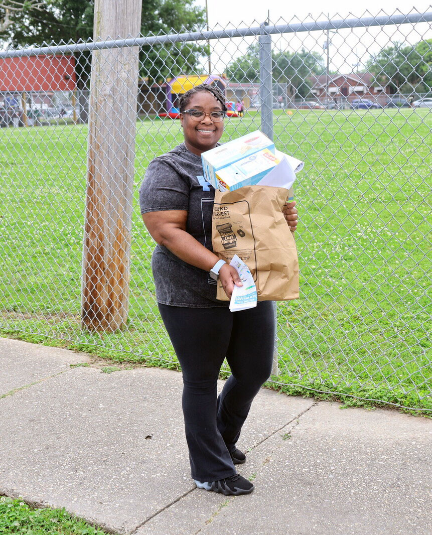 person walking and holding bags of groceries