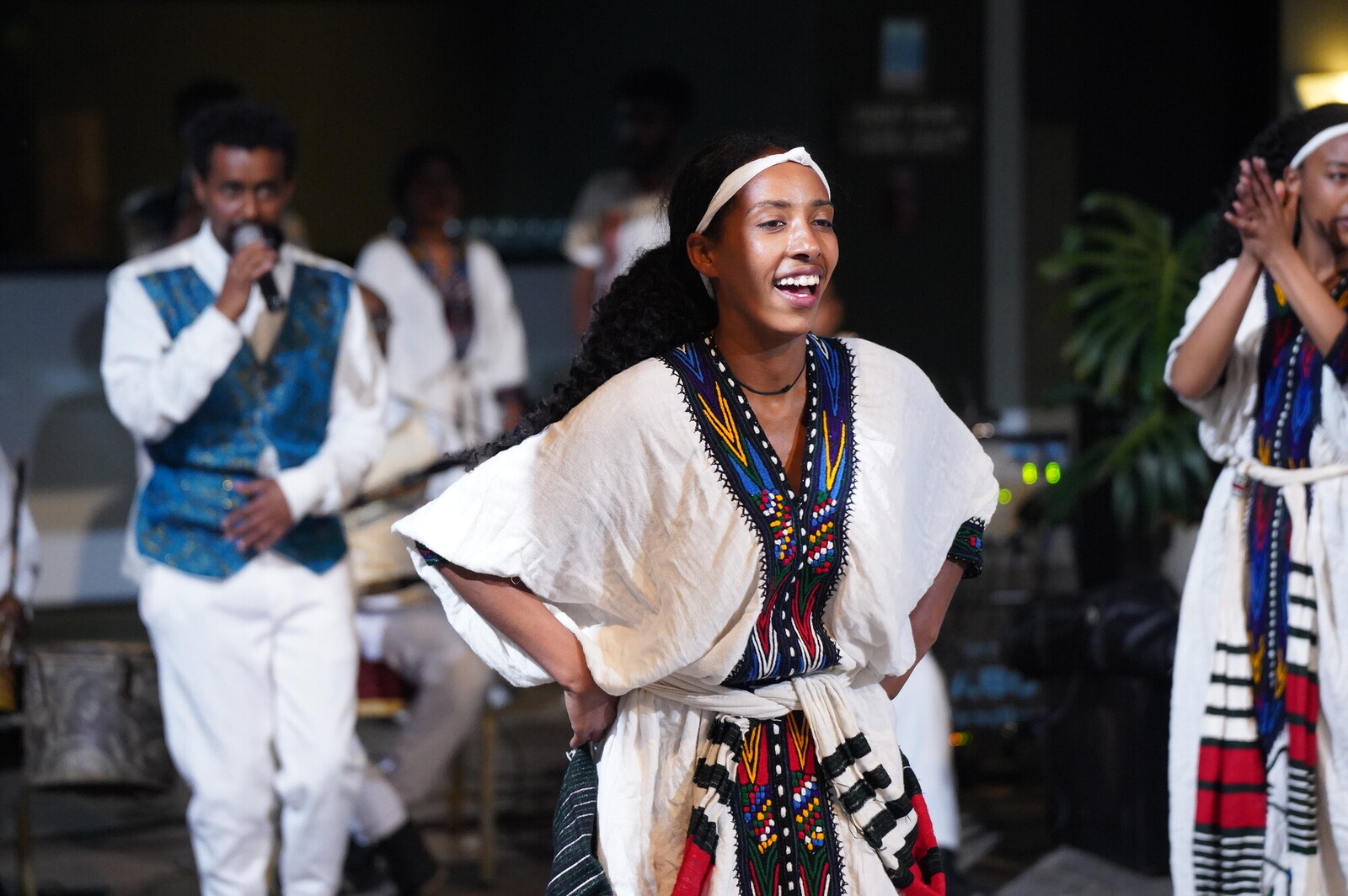 photo of people dancing in traditional african clothing